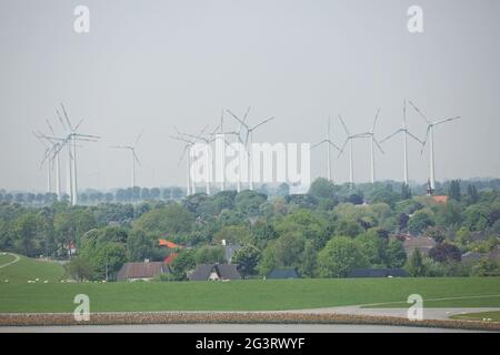 Windmühlen-Kraftwerke und Turbinen erzeugen erneuerbare grüne Energie in der Nähe des Kieler Kanals in Deutschland Stockfoto