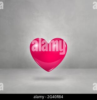 3D rosa Herz auf einem Beton Studio Hintergrund Stockfoto