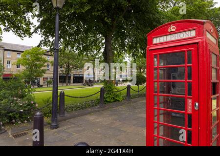 Sommertag am Norfolk Square, Glossop, Derbyshire mit einer traditionellen roten Telefondose. Stockfoto