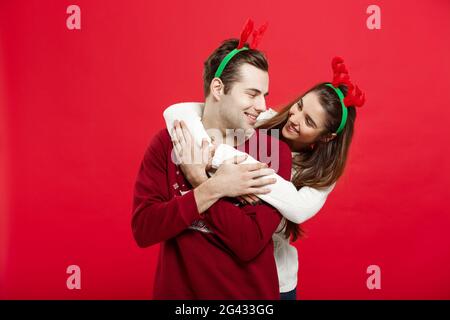 Weihnachten Konzept - Romantisches Paar in einem Weihnachten Pullover huging einander Stockfoto