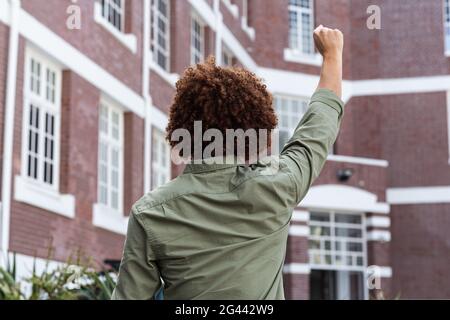 Rückansicht eines Mannes mit gemischter Rasse, der die Faust hebt Stockfoto