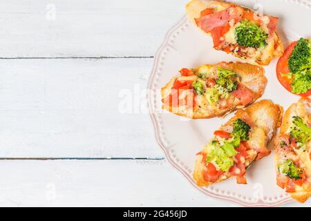 Open-Sandwich mit Schinken, Mozzarella und Tomaten auf Küchentisch, flachen Fokus Stockfoto