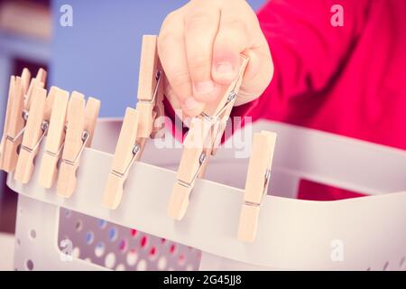 Vorschulkinder spielen mit Holzclip. Entwicklung von motorischen Fähigkeiten, Koordination und Kreativität der Kinder Stockfoto