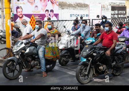 PONDICHERRY, INDIEN - Juni 2021: Alle tragen eine Maske, niemand trägt einen Helm in der Anna Salai Road. Stockfoto