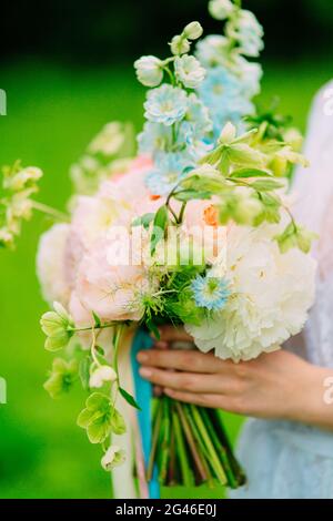 Hochzeitsstrauß von Pfingstrosen in den Händen der Braut. Hochzeit in Stockfoto