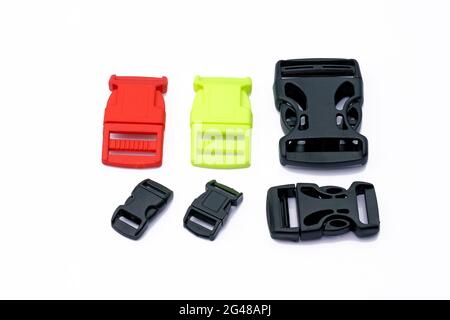 Gürtelclips aus Kunststoff, Längenversteller für Plastiktüten, verschiedene Farben. Plastikfastexes an einem Taschenriemen, an einem Rucksackgurt auf weißem Hintergrund. Stockfoto