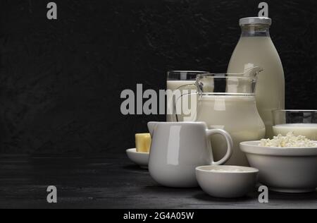 Milchprodukte auf schwarzem Holzhintergrund mit Kopierraum Stockfoto