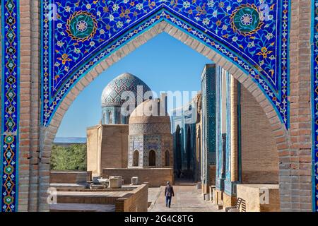 Blick über die Mausoleen und Kuppeln des historischen Friedhofs von Shahi Zinda durch ein Bogentor, Samarkand, Usbekistan. Stockfoto