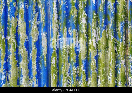 Buntes Sprenkeln löste sich von Farbschichten auf verzinkter Wellblechstruktur ab Stockfoto