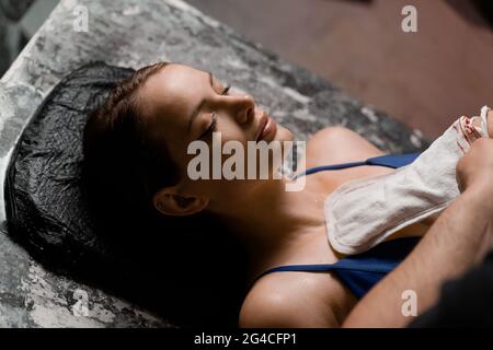 Türkische Schaummassage und Peeling mit Kese-Handschuh. Entspannung im Spa-Center. Masseur macht Massage Stockfoto