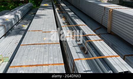 Bent metal profile channel stored at the street. Stockfoto