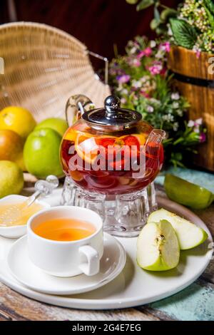 Roter Früchtetee in einer transparenten Teekane bei der Teeparty-Zeremonie. Stockfoto