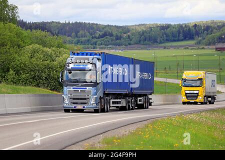 Der blaue Volvo FH Truck Element-Trans und der gelbe DAF XF Sattelanhänger transportieren Güter an einem schönen Tag auf der Umgehungsstraße von Salo. Salo, Finnland. 28.Mai 2021. Stockfoto