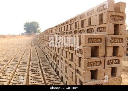 Rewari, Haryana/Indien - Herstellung von Ziegelsteinen. Roher Ziegel, der in Stapeln zum Trocknen ausgelegt ist. Stockfoto