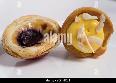 Tropischer Ananaskuchen und Pastell de Nata auf weißem Hintergrund Stockfoto