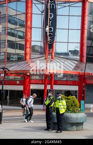 Sheffield UK: 17. April 2021: Zwei maskierte Polizeibeamte überwachen die Straßen des Stadtzentrums von Sheffield, während es nach der Pandemie-Lockdow wieder eröffnet wird Stockfoto