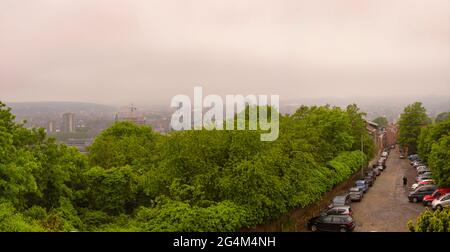 LÜTTICH, BELGIEN - 05. Jun 2021: Lüttich, Belgien, 2021. Juni: Panoramablick auf die Stadt Lüttich an einem trüben, nebligen Tag mit Street au peri und Coteaux de Stockfoto