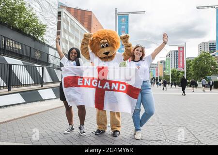 London, Großbritannien. Juni 2021. Fußballfan kleidet sich in Löwen-Kostüm, während die anderen beiden die Union Jack-Flagge zur Unterstützung Englands halten.Fußballfans versammeln sich heute wieder im Wembley-Stadion, um das letzte Gruppenspiel der UEFA Euro 2020 für das englische Team zu unterstützen. England hat sich bereits vor dem Spiel gegen die Tschechische Republik für die letzten 16 der UEFA qualifiziert. Kredit: SOPA Images Limited/Alamy Live Nachrichten Stockfoto