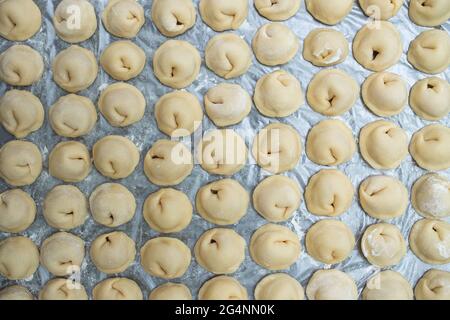 Hausgemachte rohe Knödel auf dem Tisch Draufsicht. Stockfoto