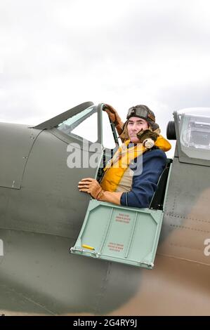 Re-enactor in der historischen Jagdpilotenkleidung im Cockpit einer Spitfire Mk.I. Zweiter Weltkrieg Battle of Britain Ära fliegende Kleidung und Ausrüstung Stockfoto