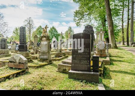 Broumov, Tschechische republik - 21. Mai 2021. Grabsteine und Gräber im Renaissance- und Empire-Stil auf dem alten Friedhof mit der hölzernen Marienkirche aus dem 13. jahrhundert Stockfoto