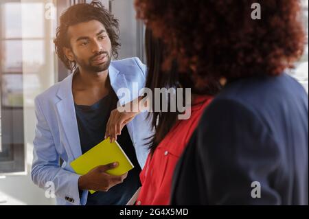 Geschäftsmann im Gespräch mit Unternehmerinnen im Büro Stockfoto