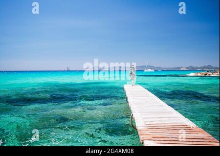 Reife Frau, die auf dem Steg auf Formentera Island steht Stockfoto