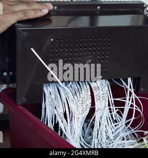 Aus der Maschine entkommenes Raspelpapier. Draufsicht. Aktenvernichtung von Dokumenten aus Sicherheitsgründen. Stockfoto