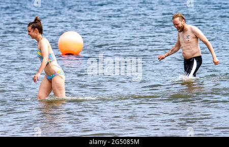 Dundee, Tayside, Schottland, Großbritannien. Juni 2021. UK Wetter: Ein sonniger und warmer Tag mit einer kühlen westlichen Brise durch Nordostschottland mit Temperaturen bis zu 19 Grad Ein junges Paar Sofie Wilcox und Andrew Smith verbringen Zeit zusammen, um die Sonne zu genießen, während sie Spaß am Fluss Tay am Broughty Ferry Beach in Dundee haben. Kredit: Dundee Photographics/Alamy Live Nachrichten Stockfoto