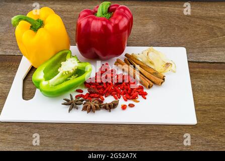 Still – Life-Konzept süßer Paprika (Paprika) und verschiedene Gewürze für China Pharmaceutical Equipment (Goji-Beeren, Zimt, Anis, Galgant Stockfoto