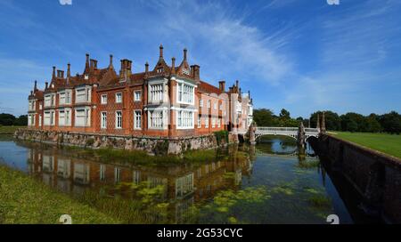 Helmingham Hall mit Graben Brücken und Reflexionen. Stockfoto