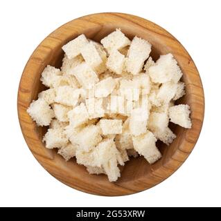 Zwieback. Gebratenes Brot in einer Holzschüssel isoliert auf weißem Hintergrund. Caesar Salat Zutaten. Leckere Snacks. Draufsicht. Datei enthält Stockfoto