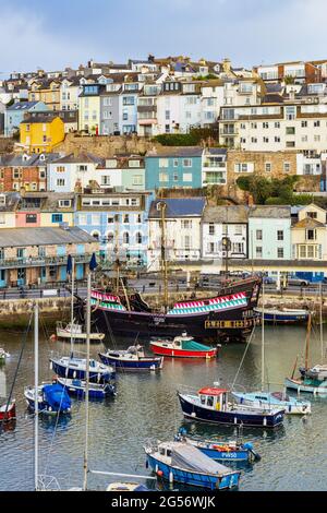 Blick von der King Street auf den alten Hafen von Brixham, mit der Replik Golden Hind, die am Kai vertäut ist. Stockfoto