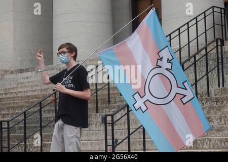 Ein Protestler hält die Trans-Flagge und schnappt in Solidarität mit anderen Rednern, Während der Demonstration standen Transgender Rights Advocates mittags vor dem Ohio State House, um gegen eine Änderung eines Gesetzes, das Transgender-Frauen die Teilnahme am High School- und College-Frauensport verbieten würde, zu protestieren und die Aufmerksamkeit auf diese zu lenken. Der ursprüngliche Gesetzentwurf, den dieses Transgender-Verbot hinzugefügt wurde, sah eine Entschädigung für Studenten vor, die von ihrem Namen, ihrem Image und ihrem Aussehen profitieren sollten. Die Ergänzung dieses Gesetzesentwurfs durch ein Transgender-Verbot war eine Überraschung, da es bereits ein Transgender-Embargo gibt. (Foto Stockfoto