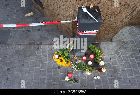 Würzburg, Deutschland. Juni 2021. 26. Juni 2021, Bayern, Würzburg: Kerzen und Blumen liegen vor einem geschlossenen und abgesperrten Laden in der Innenstadt. In Würzburg griff ein Mann am Vortag zufällig Menschen mit einem Messer an. Drei Menschen starben, mindestens fünf wurden schwer verletzt. Foto: Karl-Josef Hildenbrand/dpa Quelle: dpa picture Alliance/Alamy Live News Stockfoto