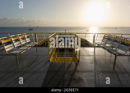 Das Oberdeck einer RoRo-Fähre mit leeren Stühlen, die in der Nähe der Küste von Cancun in Mexiko fährt Stockfoto