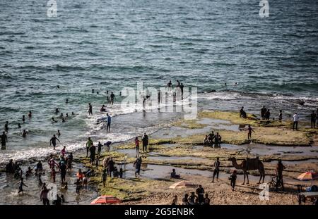 Gaza, Palästina. Juni 2021. Menschen, die Spaß am Strand in Gaza City haben. Palästinenser genießen den mediterranen Strand in Deir al-Balah mitten im Gazastreifen. Die Küste ist der einzige Auslauf für die Palästinenser. Kredit: SOPA Images Limited/Alamy Live Nachrichten Stockfoto