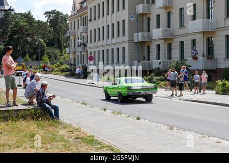 Königs Wusterhausen, Deutschland. Juni 2021. Die Menschen beobachten die Oldtimer-Parade 'Rummblubbern' in und um Königs Wusterhausen. Für die rund zweistündige Autokolonne werden mehr als 400 amerikanische Fahrzeuge erwartet. Die Strecke der Autokolonne wird etwa 40 km lang sein. Die Organisatoren erwarten Tausende von Gästen entlang der Strecke und in den Restaurants. Foto: Gerald Matzka/dpa Quelle: dpa picture Alliance/Alamy Live News Stockfoto