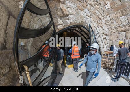 Jerusalem, Israel. Bauarbeiter arbeiten in den Tunneln der Westmauer, einem der heiligsten Orte des Judentums, auch bekannt als die „Wailling Wall“, mit Gesichtsmasken und Sicherheitsausrüstung, um sie während der COVID-Pandemie sicher zu halten. Stockfoto