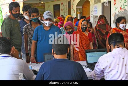 Beawar, Rajasthan, Indien, 27. Juni 2021: Die Begünstigten stehen in Schlangen, um während einer speziellen Impfkampagne in einem Impfzentrum in Beawar einen COVID-19-Impfstoff zu erhalten. Der erste Fall der Delta-plus-Variante des Coronavirus in Rajasthan wurde in Bikaner gefunden. Insgesamt wurden 48 Fälle von Delta plus und vier Todesfälle in 10 indischen Bundesstaaten gemeldet. Kredit: Sumit-Samarwat/Alamy Live Nachrichten Stockfoto