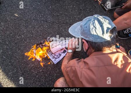 Barcelona, Spanien. Juni 2021. Ein Protestler sah während der Demonstration brennende Fotos des spanischen Königs, des spanischen Königs, des spanischen Königs, des spanischen Königs, des spanischen Königs, des spanischen Königs, des spanischen Königs, des spanischen Königs, des spanischen Königs, des spanischen Königs, des spanischen Königs, des spanischen Königs. Ein jährlicher Kongress rund um die Welt der mobilen Kommunikation in der Fira de Barcelona, einer Messeinstitution in Barcelona. Demonstranten verbrannten Fotos des Königs vor dem Veranstaltungsort. Kredit: SOPA Images Limited/Alamy Live Nachrichten Stockfoto