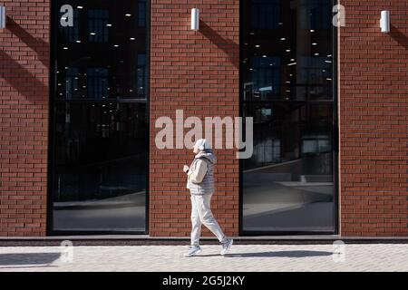 Weitwinkel-Seitenansicht Porträt einer modernen Frau aus dem Nahen Osten, die in einer Stadt gedreht und im Kopierbereich herumläuft Stockfoto