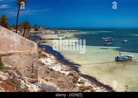 Herrliche Aussicht auf die Mittelmeerküste mit Birkenwasser, weißem Sandstrand und einem Fischerboot. Stockfoto