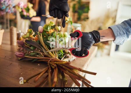 Erfahrene weibliche Floristin, die ein Blumenarrangement macht Stockfoto