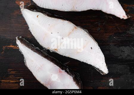 Gefrorene Filets von weißen Fischen, pollock Set, auf altem dunklen Holztisch Hintergrund, Draufsicht flach liegend Stockfoto