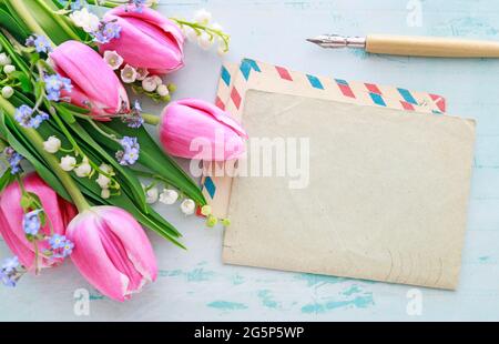 Bouquet of pink tulips, lily of the valley and forget me not flowers. Spring decor Stock Photo