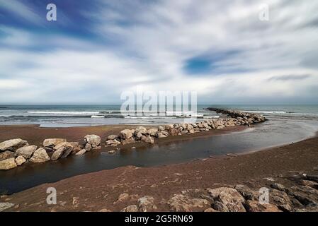 Flussmündung am Strand neben dem Steg Stockfoto