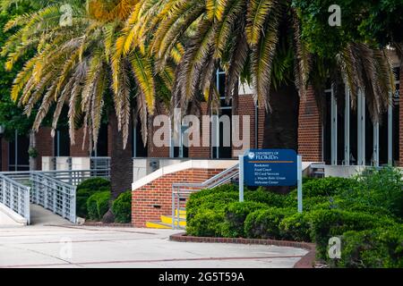 Gainesville, USA - 27. April 2018: University of Florida unterzeichnet auf dem Campus der UF mit Gebäude für Buchhandlung, Lebensmittelgericht, personalausweise und Willkommenszentrum Stockfoto