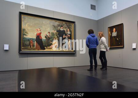 BELGIEN. FLANDERN. BRÜGGE.EHEPAAR, DIE SICH EIN GEMÄLDE AUS DER PRIMITIVEN FLÄMISCHEN ZEIT IM GROENINGEMUSEUM ANSEHEN. Stockfoto