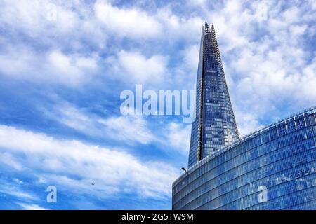London, Großbritannien - 29. September 2016: Das Nachrichtengebäude und der Shard, mit kleinem Flugzeug und blauem Himmel im Hintergrund.. Entworfen von Renzo Piano, The News B Stockfoto